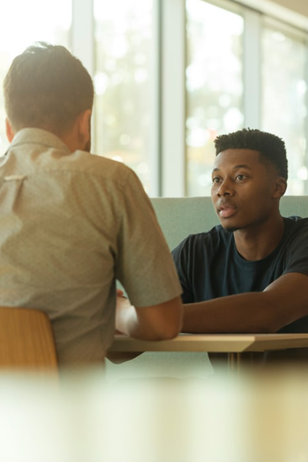 Two people chatting at a table